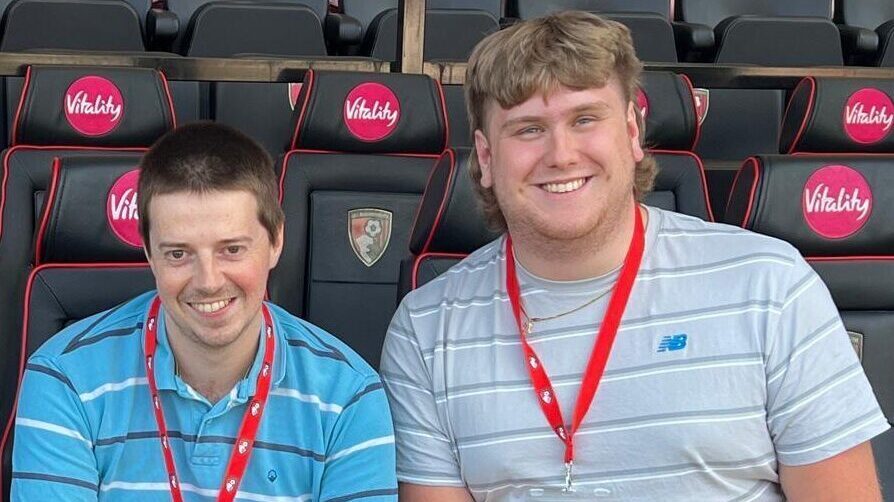 Tom Crocker (L) and Jack Tanner (R) pictured sat in the away dugout at AFC Bournemouth.